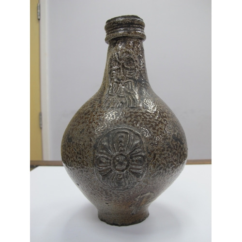 1038 - A German Salt Glazed Bellarmine Jug, moulded with stylised floral roundel and mask face to the neck,... 