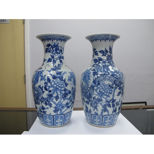 1089 - A Pair of Late XIX Century Chinese Pottery Vases, of baluster form, painted in blue with dragons ent... 