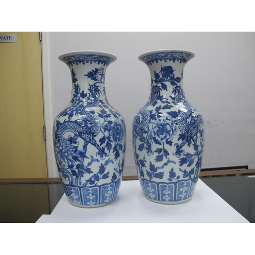 1089 - A Pair of Late XIX Century Chinese Pottery Vases, of baluster form, painted in blue with dragons ent... 