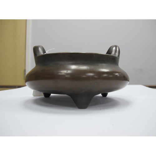 1099 - A Chinese Bronze Tripod Censer, of two handled circular form, six character mark to base, 12.5cm dia... 