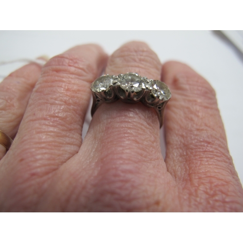 218 - A Large Three Stone Diamond Ring, the brilliant cut stones claw set, stamped 