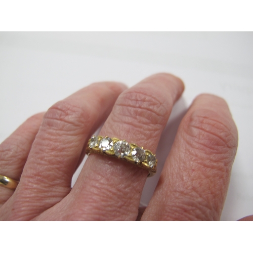 221 - An Edwardian 18ct Gold Five Stone Diamond Ring, the graduated old cut stones within scroll carved se... 