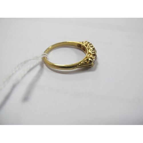 221 - An Edwardian 18ct Gold Five Stone Diamond Ring, the graduated old cut stones within scroll carved se... 