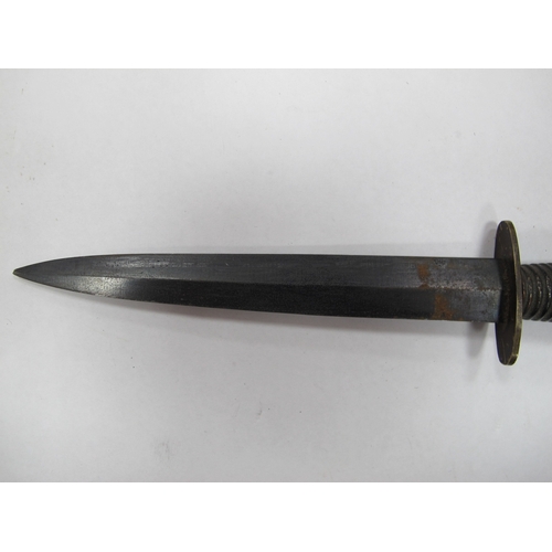 515 - A British Army Fairbairn Sykes Commando Style fighting Knife, with leather scabbard. (Buyer to fully... 