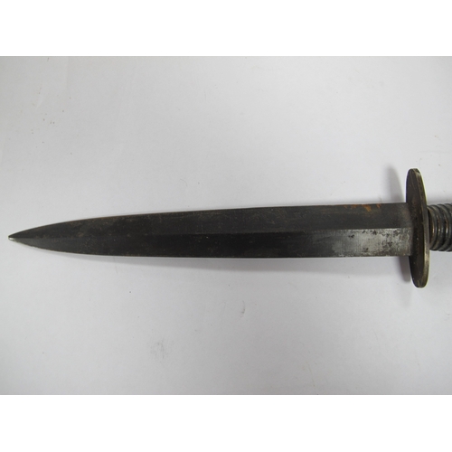 515 - A British Army Fairbairn Sykes Commando Style fighting Knife, with leather scabbard. (Buyer to fully... 