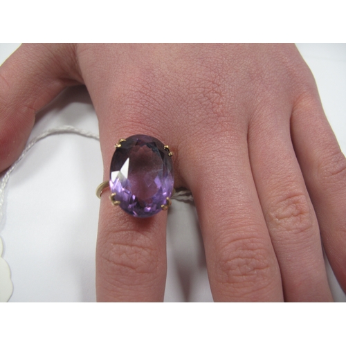 168 - A Large Amethyst Single Stone Dress Ring, oval claw set (finger size P1/2) (6grams).