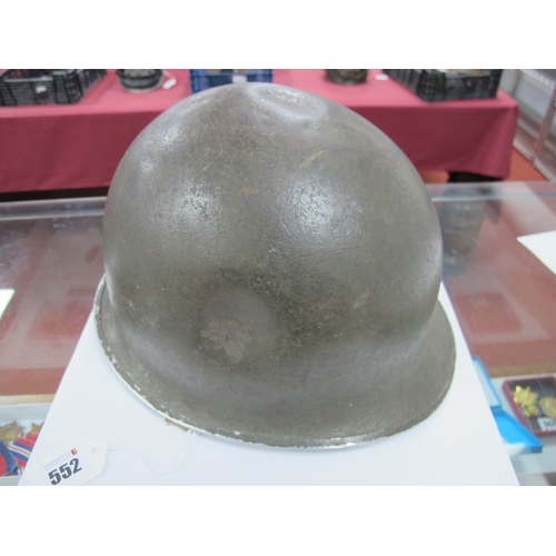 552 - A WWII American M1 Steel Combat Helmet,  with textured paint finish, some indentations to helmet she... 