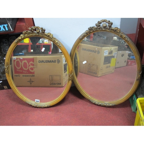 1060 - A Pair of Oval Wall Mirrors, each with wreath cresting to gilt over reeded wooden frame,45.5cm wide.... 