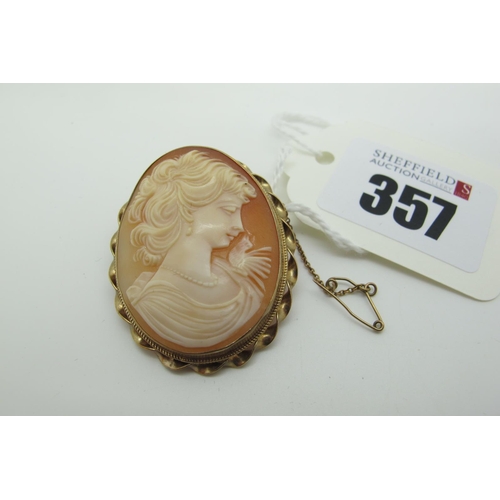 357 - A 9ct Gold Oval Shell Carved Cameo Brooch, depicting female profile, collet set with twisted detail.