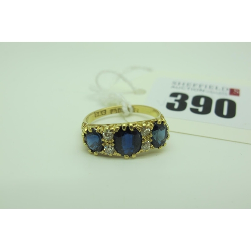 390 - An 18ct Gold Sapphire and Diamond Ring, graduated oval set, with old cut diamond highlights, Birming... 