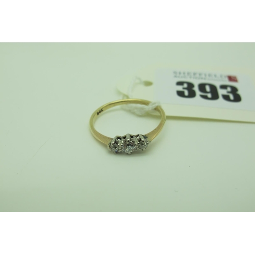 393 - A Dainty Three Stone Diamond Ring, the graduated old cut stones claw set (finger size M).