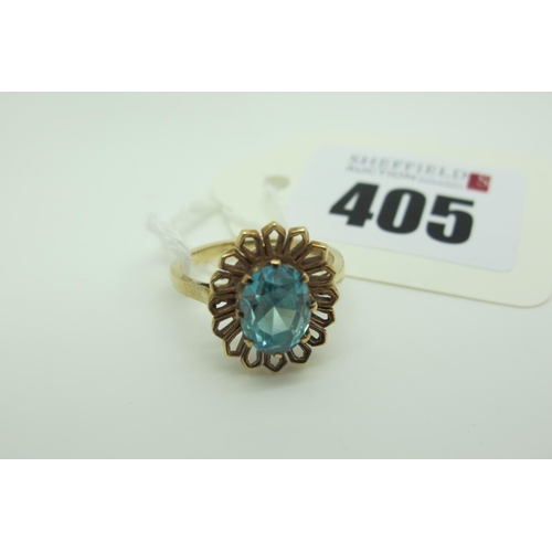 405 - A 9ct Gold Blue Zircon Single Stone Dress Ring, oval claw set (finger size N) (3.6grams).