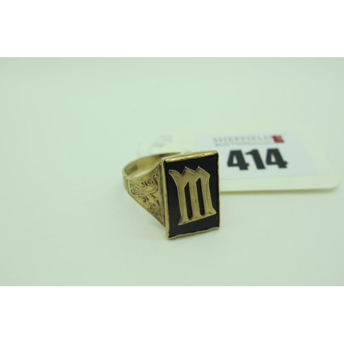 414 - A 9ct Gold Gent's Signet Ring, the rectangular inset panel with applied 'M' initial, between wide or... 