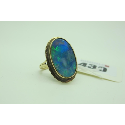 430 - A Large Black Opal Doublet Oval Panel Ring, collet set between bifurcated shoulders (finger size N).