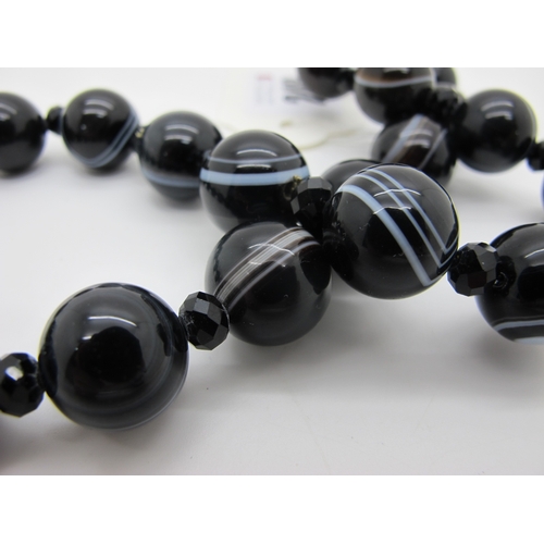 248 - A Banded Agate Bead Necklace, composed of uniform beads with faceted French Jet bead spacers.