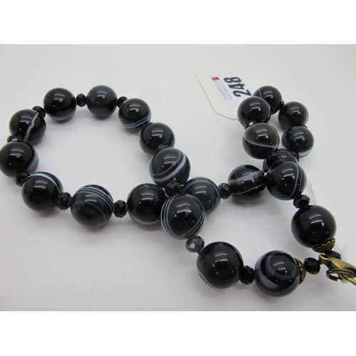 248 - A Banded Agate Bead Necklace, composed of uniform beads with faceted French Jet bead spacers.