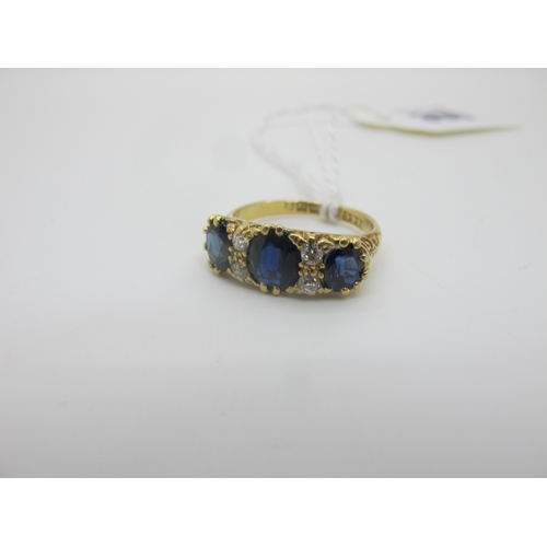 390 - An 18ct Gold Sapphire and Diamond Ring, graduated oval set, with old cut diamond highlights, Birming... 