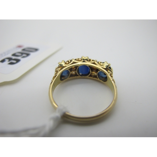 390 - An 18ct Gold Sapphire and Diamond Ring, graduated oval set, with old cut diamond highlights, Birming... 