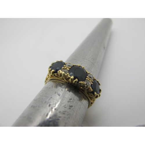 390 - An 18ct Gold Sapphire and Diamond Ring, graduated oval set, with old cut diamond highlights, Birming... 