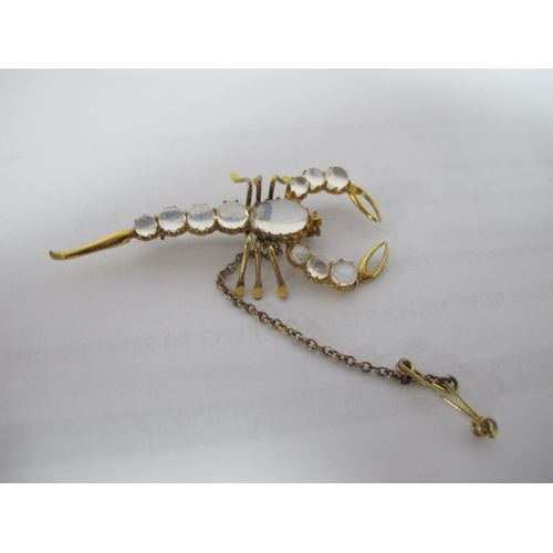 306 - A Novelty Moonstone Inset Scorpion Brooch, graduated circular and oval claw set, approximately 5.5cm... 