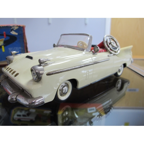 821 - A Boxed Schuco Synchromatic 5700 Tin Plate Packard Model, cream body, red interior, steering wheel p... 