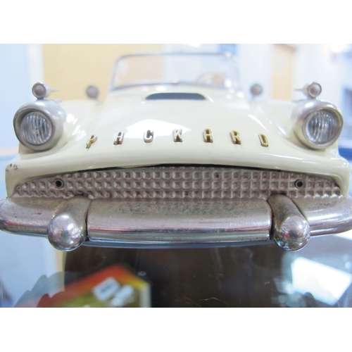 821 - A Boxed Schuco Synchromatic 5700 Tin Plate Packard Model, cream body, red interior, steering wheel p... 