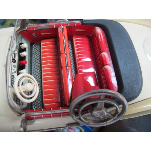 821 - A Boxed Schuco Synchromatic 5700 Tin Plate Packard Model, cream body, red interior, steering wheel p... 