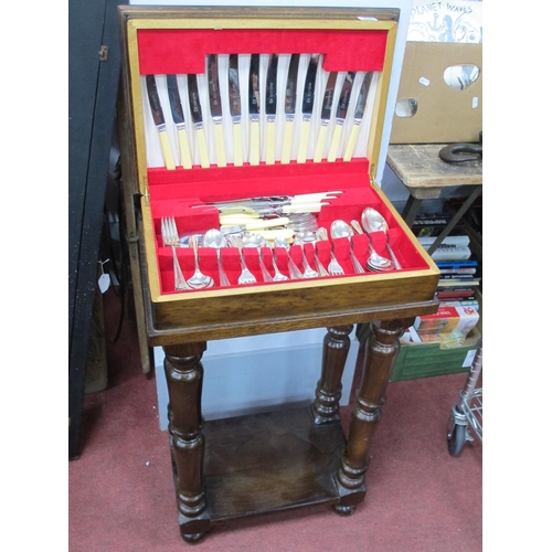 1141 - Cutlery Lewis Rose Knives and Silver Plated Spoons and Forks, in wooden table canteen, 80cm high.