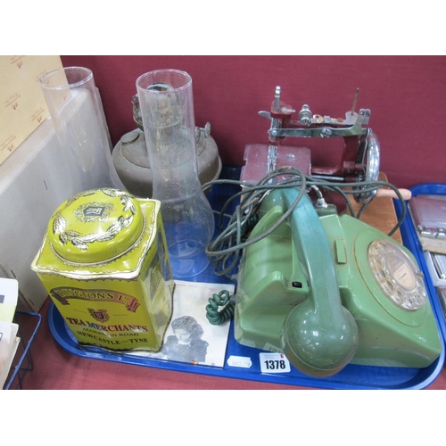 1378 - Green Plastic Anvil Telephone, 'Essex' sewing machine, oil lamp, tin:- One Tray