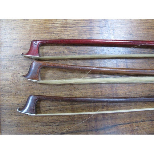 1357 - Three Violin Bows, each with nacre inset to frog, approximately 74cm long. (3).