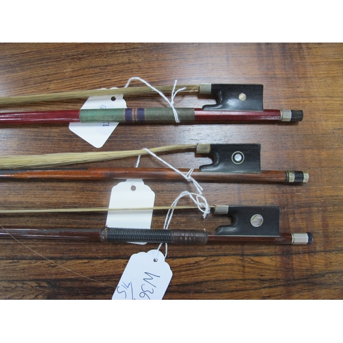 1357 - Three Violin Bows, each with nacre inset to frog, approximately 74cm long. (3).