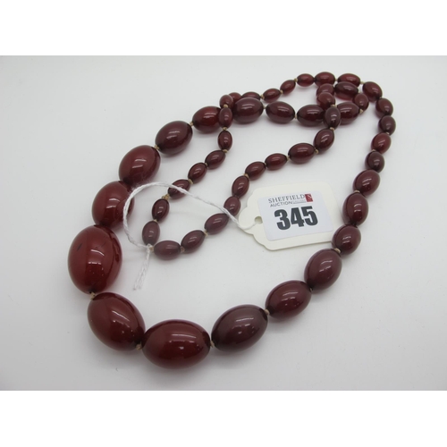 345 - A Single Strand Cherry Amber Coloured Bead Necklace, knotted.