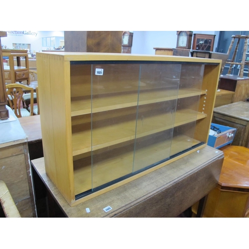 1481 - A Lightwood Bookcase, with glazed sliding doors, 101 cm wide.