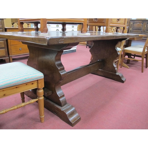 1509 - An Oak Refectory Table, on shaped trestle supports, united by a stretcher, 180cm wide.