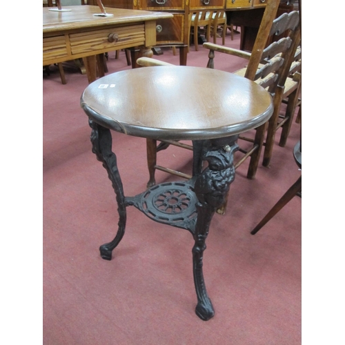 1516 - A Pub Table, with circular wooden top, 49cm diameter, on ornate black metal legs.