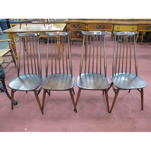 1520 - A Set of Four Ercol Dark Stained Dining Chairs, with a shaped top rail, rail supports, circular legs... 