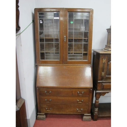 1521 - A XX Century Oak Bureau Bookcase, top with leaded glass doors, bureau with a fall front, three long ... 