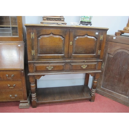 1523 - Titchmarsh & Goodwin Oak Cabinet, top with a moulded edge, twin arched cupboard doors, brushing slid... 