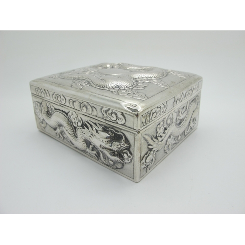 13 - Zeewo; A Chinese Trinket Box, allover profusely detailed in relief with sinuous dragons, with hinged... 