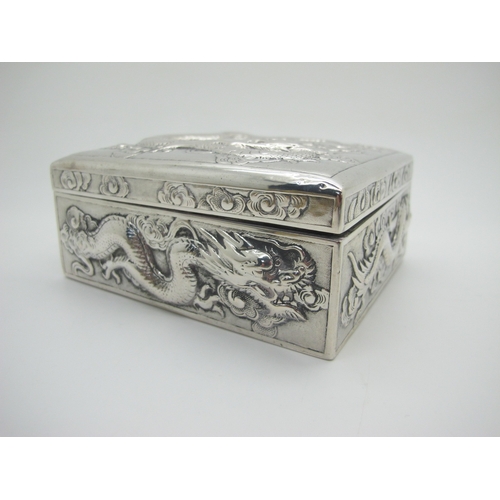 13 - Zeewo; A Chinese Trinket Box, allover profusely detailed in relief with sinuous dragons, with hinged... 