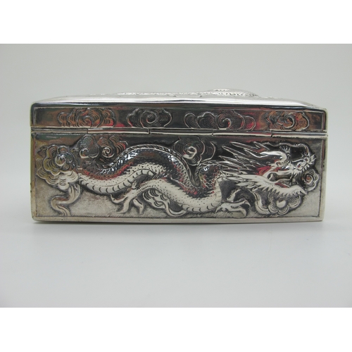 13 - Zeewo; A Chinese Trinket Box, allover profusely detailed in relief with sinuous dragons, with hinged... 