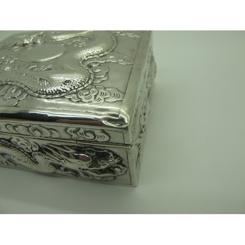 13 - Zeewo; A Chinese Trinket Box, allover profusely detailed in relief with sinuous dragons, with hinged... 