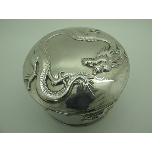 14 - Hung Chong; A Chinese Circular Lidded Box, detailed in relief with sinuous dragons, pull off cover, ... 