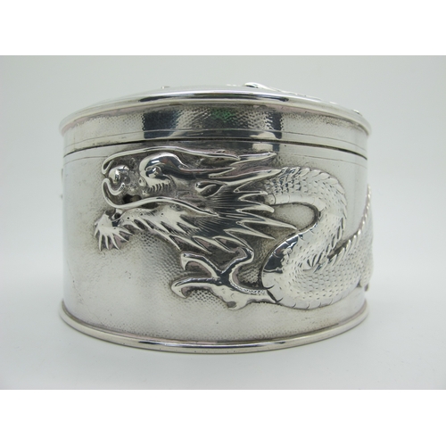 14 - Hung Chong; A Chinese Circular Lidded Box, detailed in relief with sinuous dragons, pull off cover, ... 