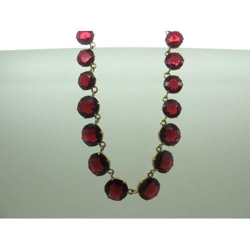 125 - A Riviere Style Necklace, graduated circular claw set, in an associated fitted case.