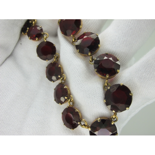 125 - A Riviere Style Necklace, graduated circular claw set, in an associated fitted case.