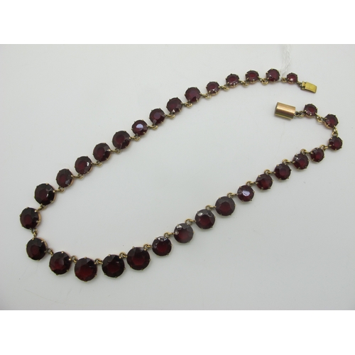 125 - A Riviere Style Necklace, graduated circular claw set, in an associated fitted case.