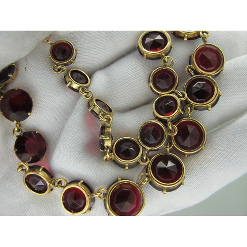 125 - A Riviere Style Necklace, graduated circular claw set, in an associated fitted case.