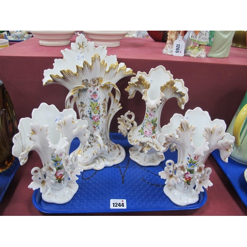 1244 - A Set of Four Continental Porcelain Vases, of frilled shaped form painted with flowers within gilt b... 