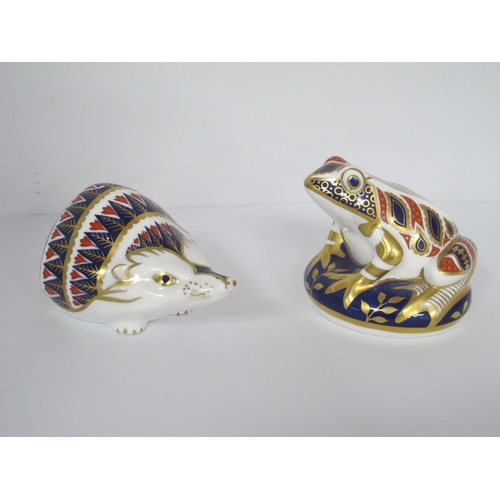 1288 - Royal Crown Derby Paperweight as a Hedgehog, (small chip under base), another of frog, both with sto... 